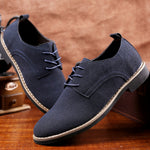 Close-up detail of men's leather and suede sneakers